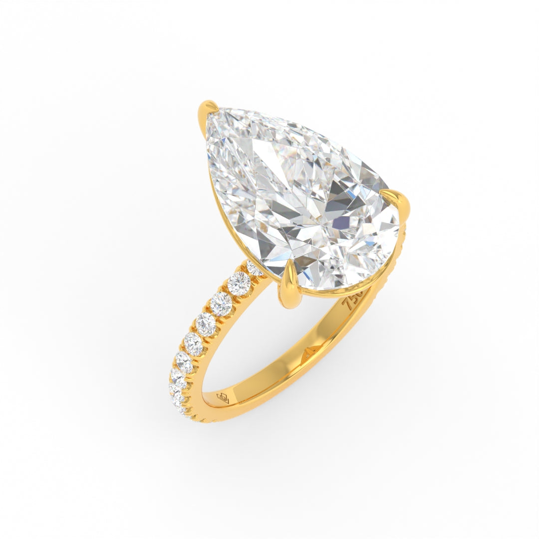 Abigail pear engagement ring with pear-cut solitaire diamond and diamond band in yellow gold