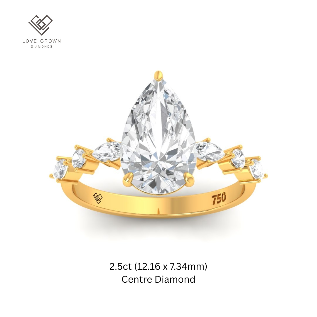 Elizabeth pear cut diamond engagement ring with marquise and round diamond band in gold setting.