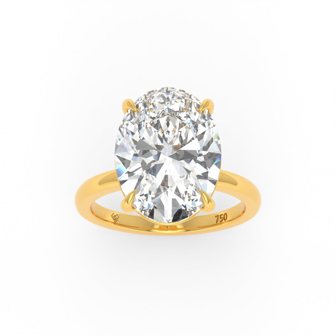 Solitaire Oval cut diamond engagement ring with 18k yellow gold band and four-claw setting
