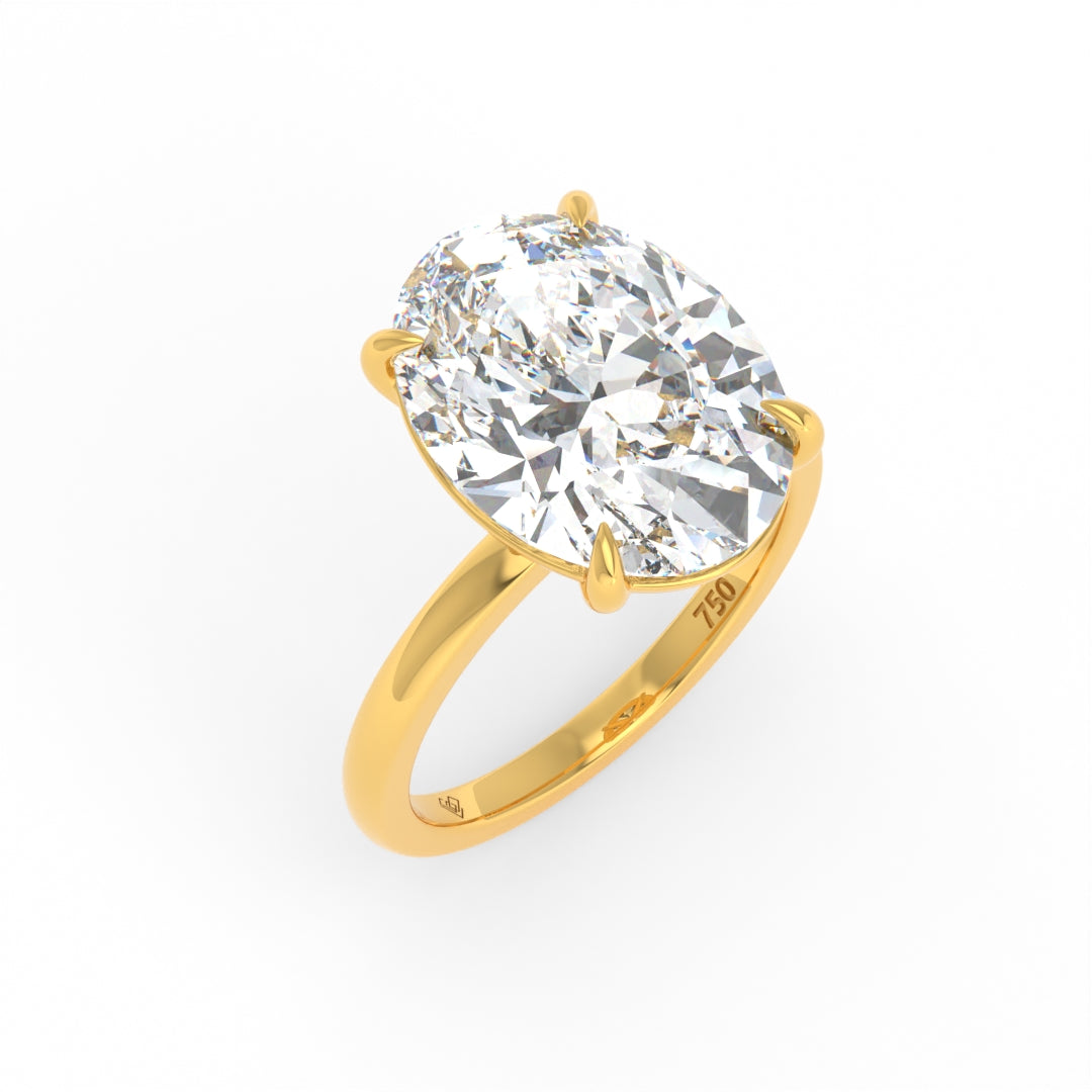 Solitaire Oval cut diamond engagement ring with 18k yellow gold band and four-claw setting