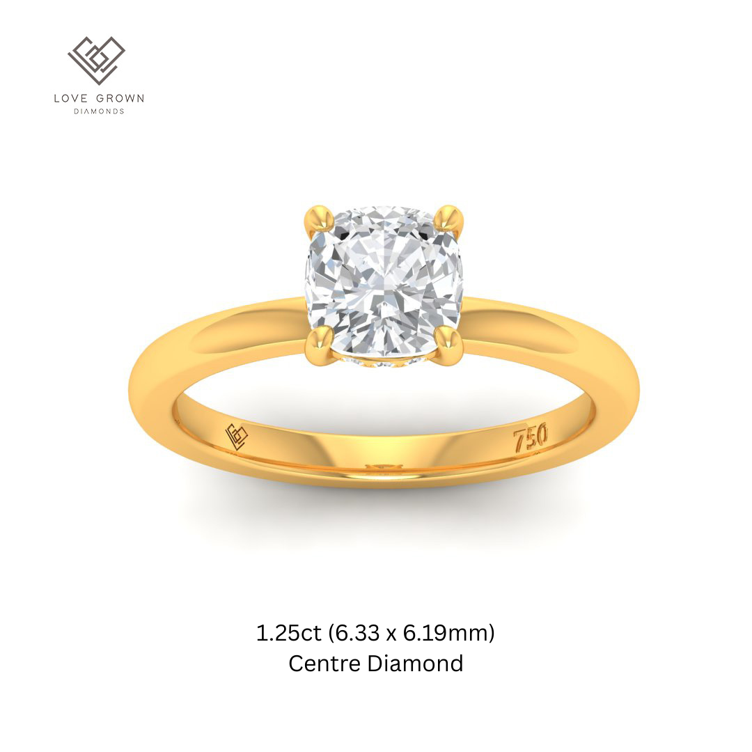 Léa cushion cut diamond engagement ring with hidden halo in gold setting.