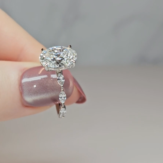 Kasandra Oval Cut Diamond Engagement Ring With A Marquise Cut Diamond Band