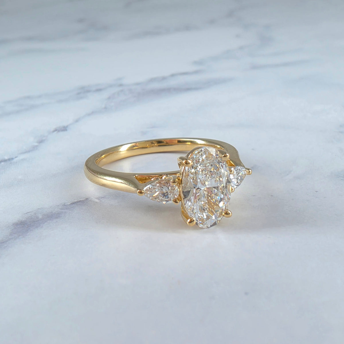 Sofia Oval Cut Diamond Engagement Ring With A Pear Cut Side Diamonds
