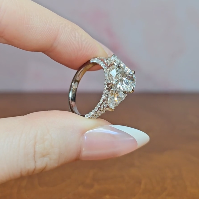 Victoria Oval Cut Diamond Engagement Ring with Heart Cut Side Diamonds and 3D Diamond Band