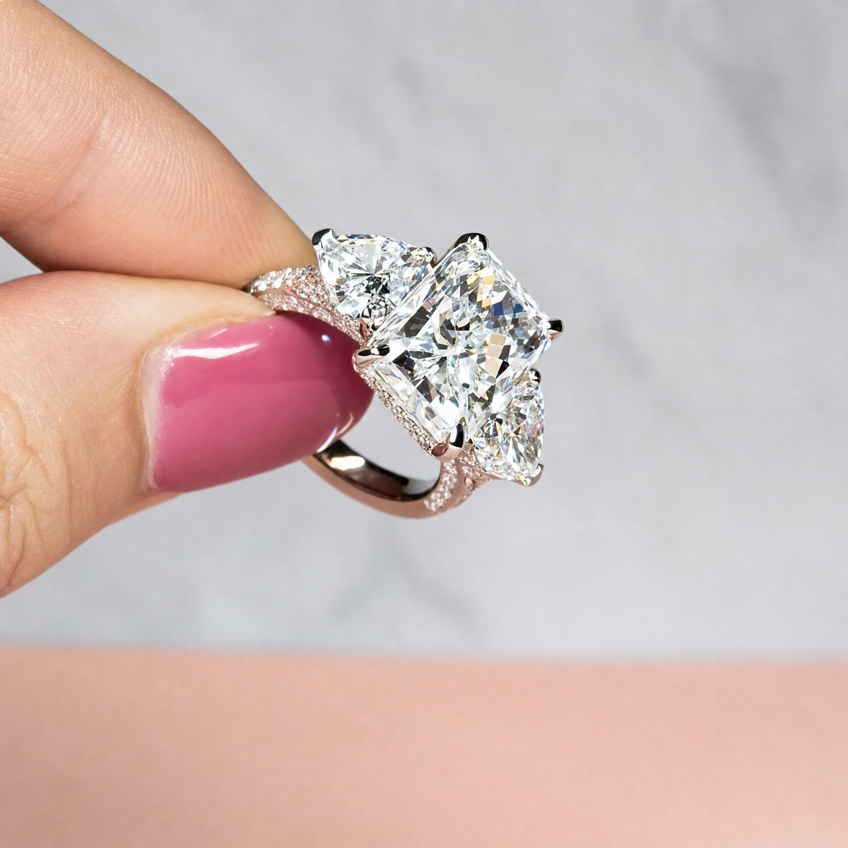 Victoria Radiant Cut Diamond Engagement Ring with Heart Cut Side Diamonds and 3D Diamond Band