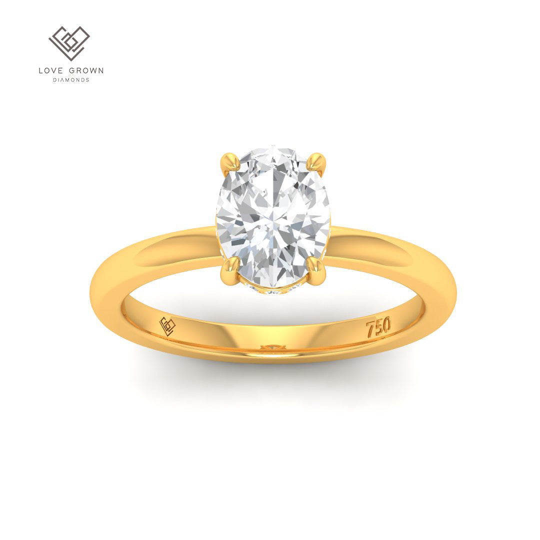 Léa Oval Cut Diamond engagement ring with hidden halo in gold setting.
