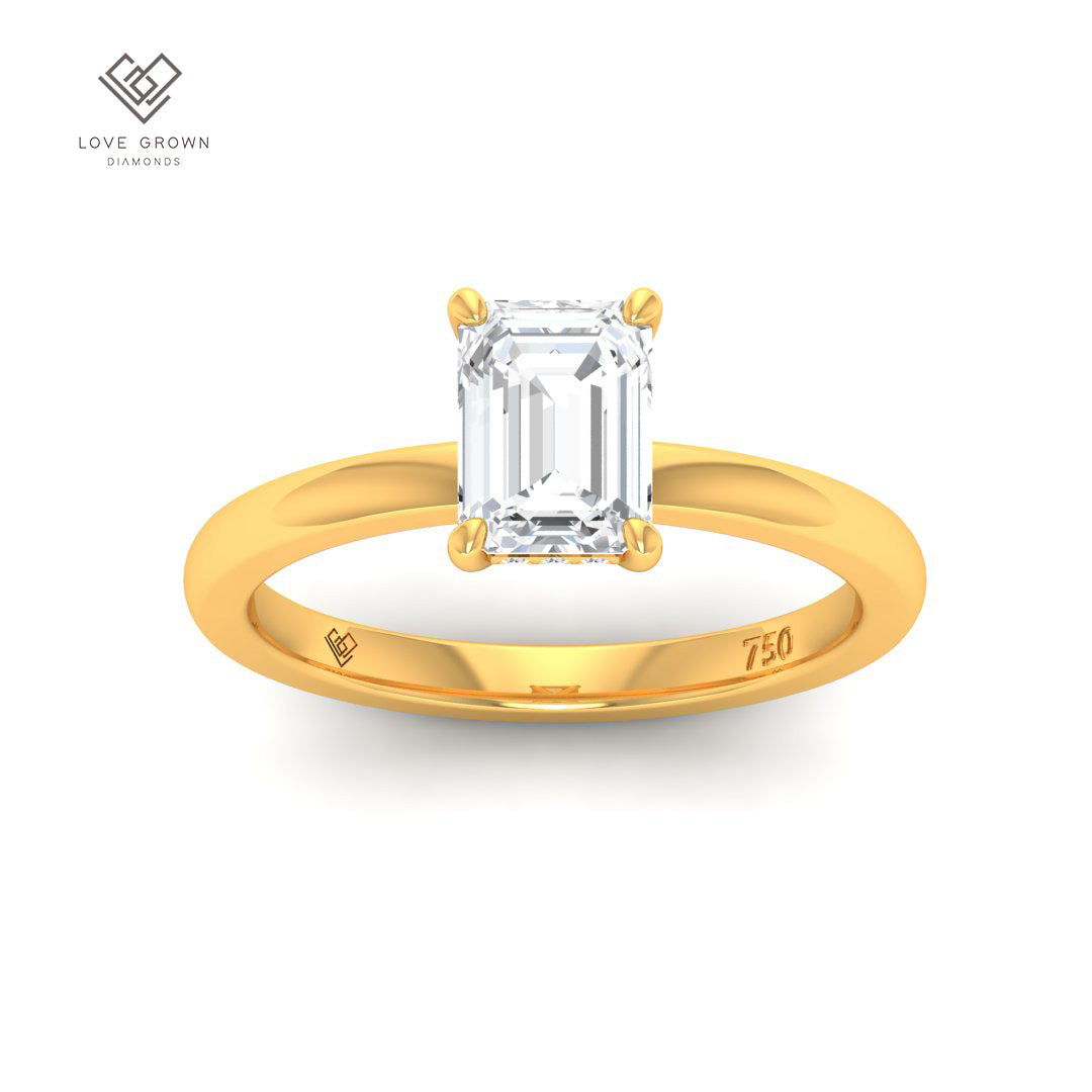 Léa Emerald Cut Diamond engagement ring with hidden halo in gold setting.