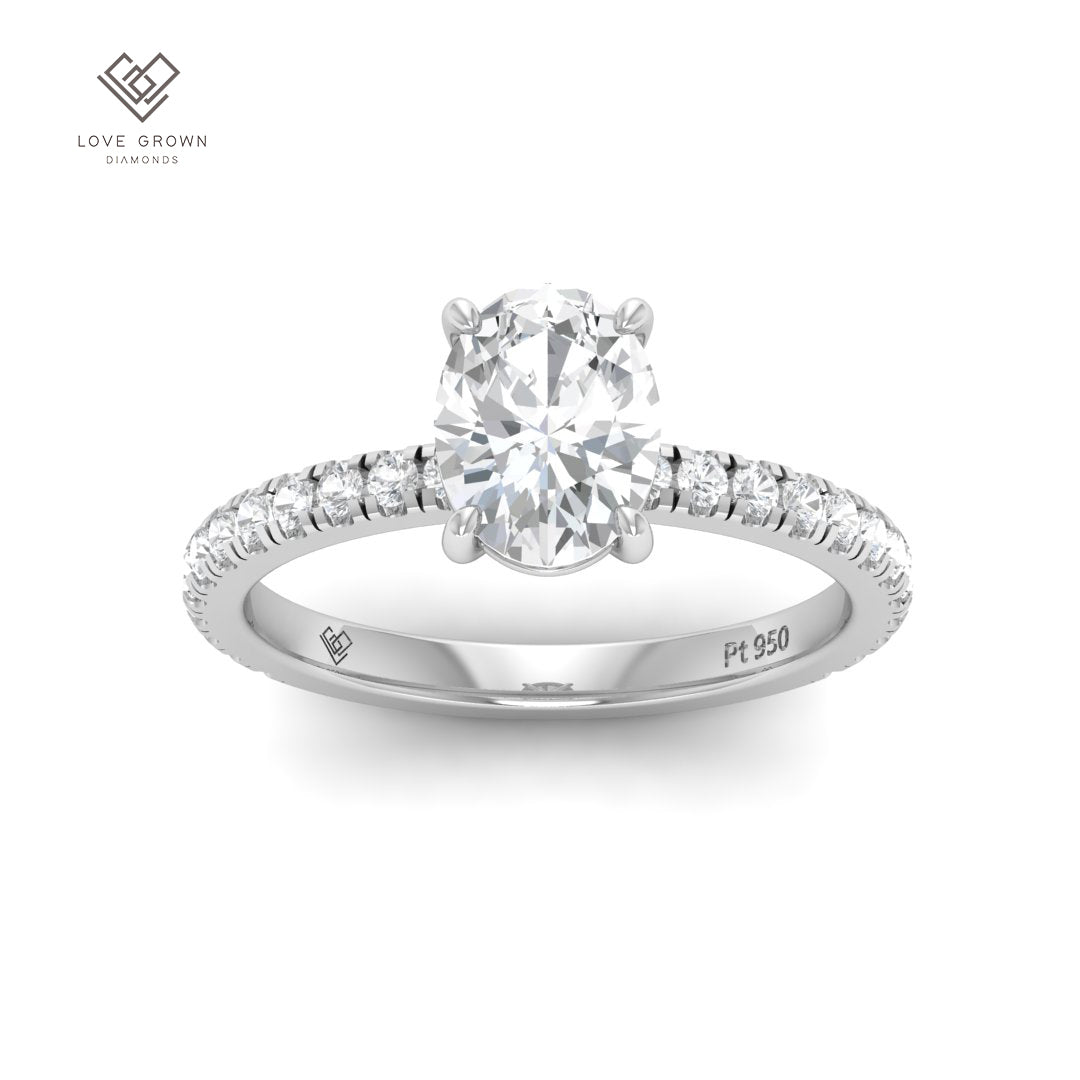 Oval cut diamond engagement ring with additional diamond band in platinum setting.