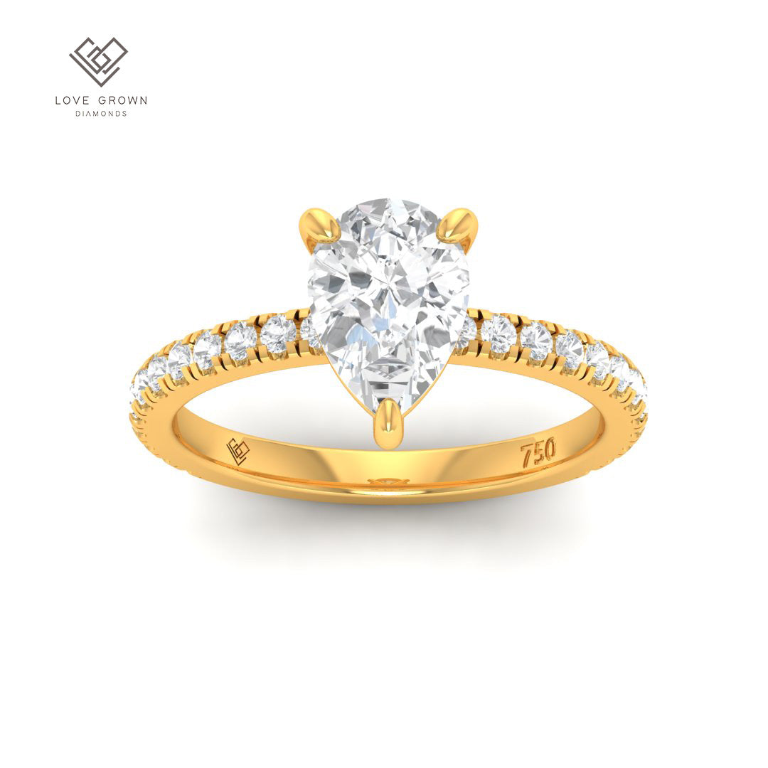 Abigail pear engagement ring with diamond band, featuring a solitaire pear cut diamond in a platinum 4 claw mount.