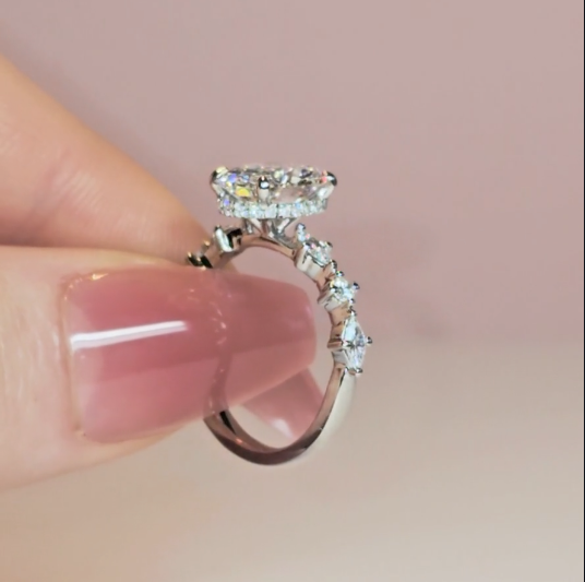 Elizabeth Oval Cut Diamond Engagement Ring With A Marquise And Round Cut Diamond Band.