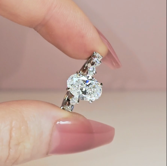Elizabeth Oval Cut Diamond Engagement Ring With A Marquise And Round Cut Diamond Band.