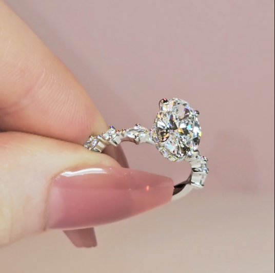 Elizabeth Oval Cut Diamond Engagement Ring With A Marquise And Round Cut Diamond Band.