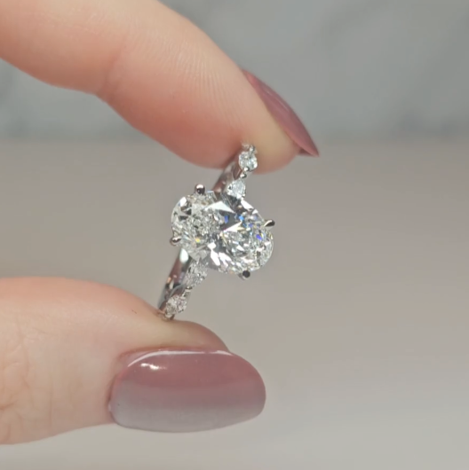 Kasandra Oval Cut Diamond Engagement Ring With A Marquise Cut Diamond Band