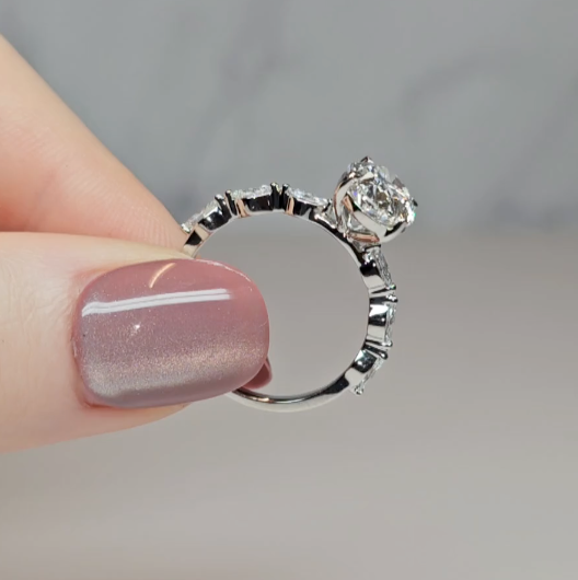 Kasandra Oval Cut Diamond Engagement Ring With A Marquise Cut Diamond Band