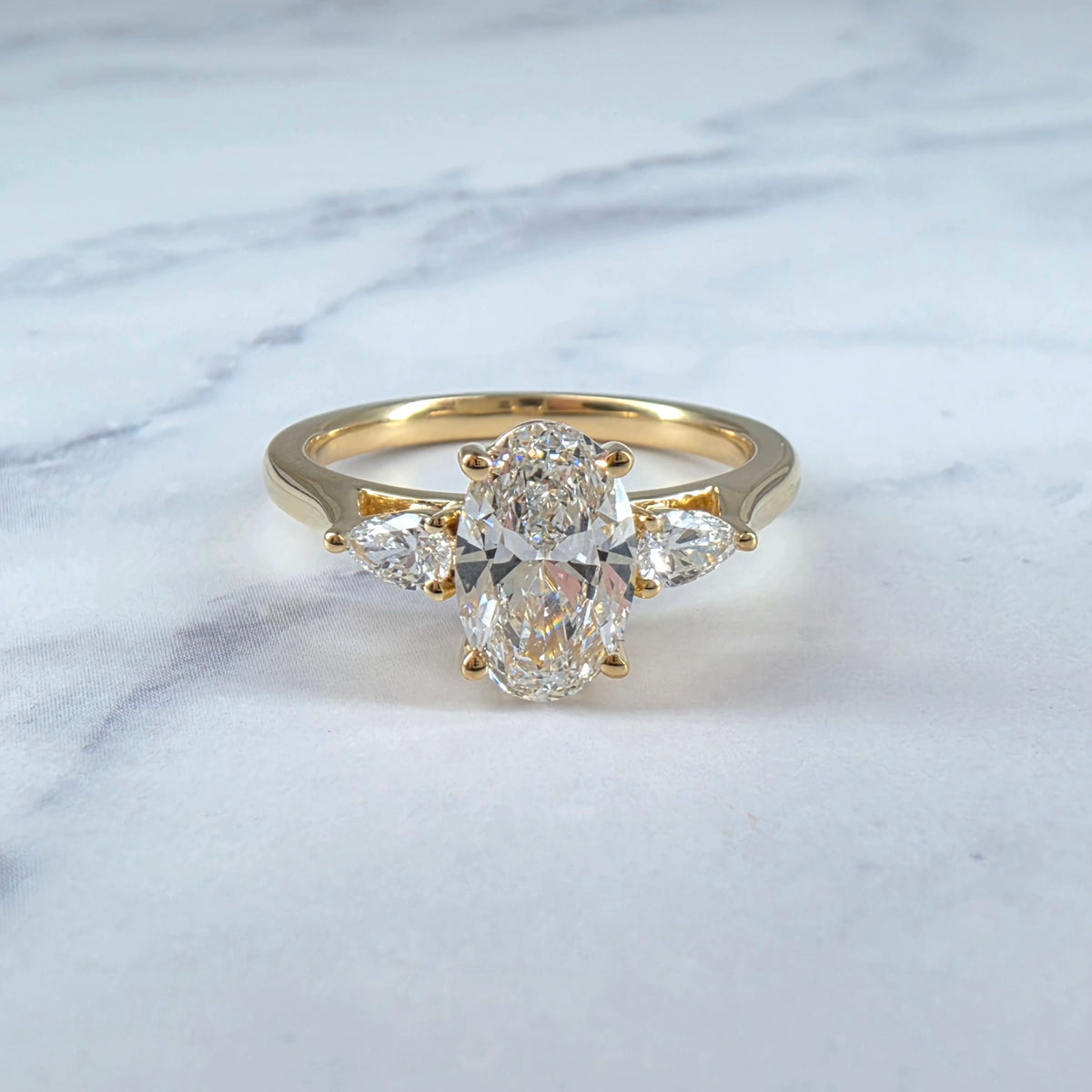 Sofia Oval Cut Diamond Engagement Ring With A Pear Cut Side Diamonds