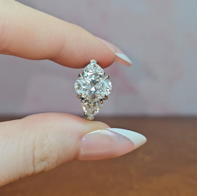 Victoria Oval Cut Diamond Engagement Ring with Heart Cut Side Diamonds and 3D Diamond Band
