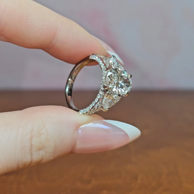 Victoria Oval Cut Diamond Engagement Ring with Heart Cut Side Diamonds and 3D Diamond Band