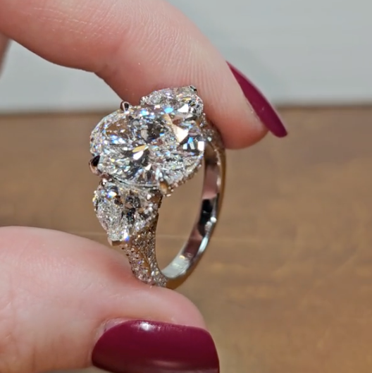 Victoria Oval Cut Diamond Engagement Ring with Heart Cut Side Diamonds and 3D Diamond Band