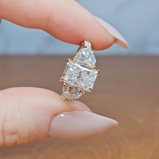 Victoria Radiant Cut Diamond Engagement Ring with Heart Cut Side Diamonds and 3D Diamond Band