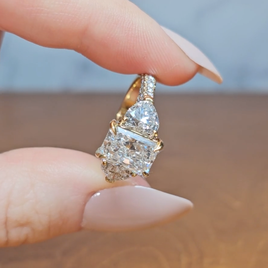 Victoria Radiant Cut Diamond Engagement Ring with Heart Cut Side Diamonds and 3D Diamond Band