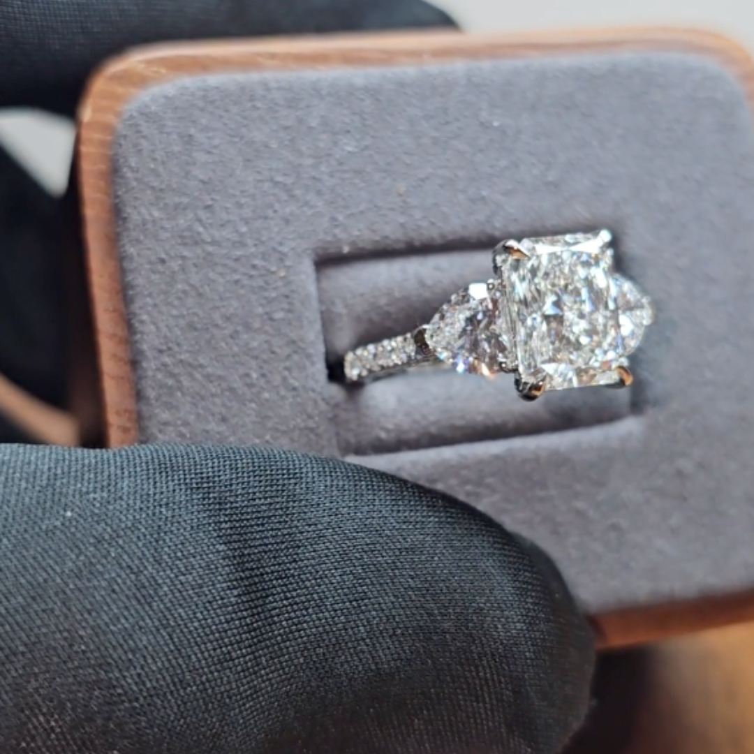 Victoria Radiant Cut Diamond Engagement Ring with Heart Cut Side Diamonds and 3D Diamond Band