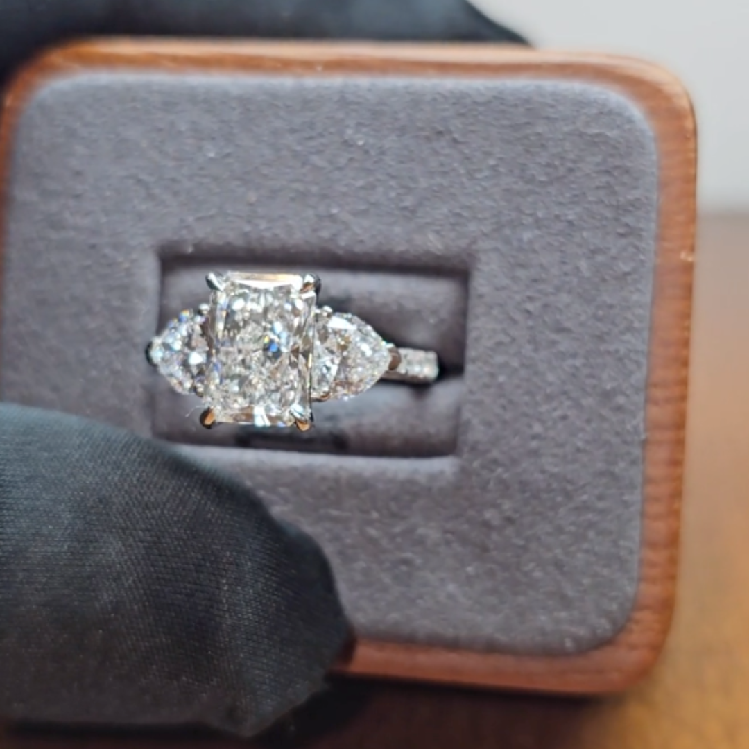 Victoria Radiant Cut Diamond Engagement Ring with Heart Cut Side Diamonds and 3D Diamond Band