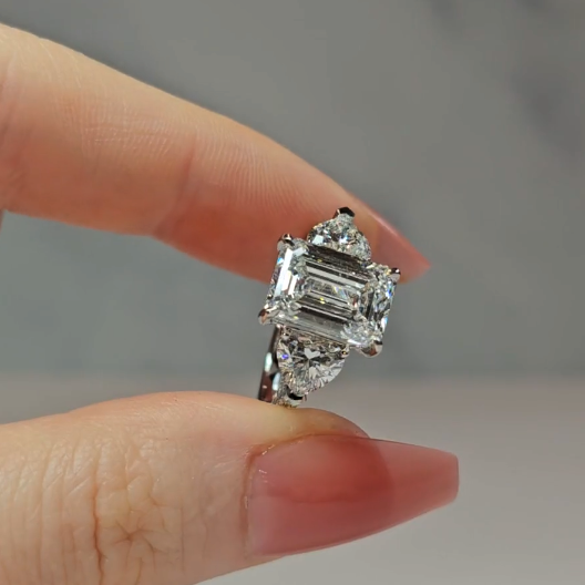 Victoria Emerald Cut Diamond Engagement Ring with Heart Cut Side Diamonds and 3D Diamond Band