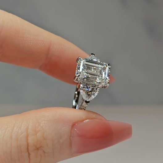 Victoria Emerald Cut Diamond Engagement Ring with Heart Cut Side Diamonds and 3D Diamond Band