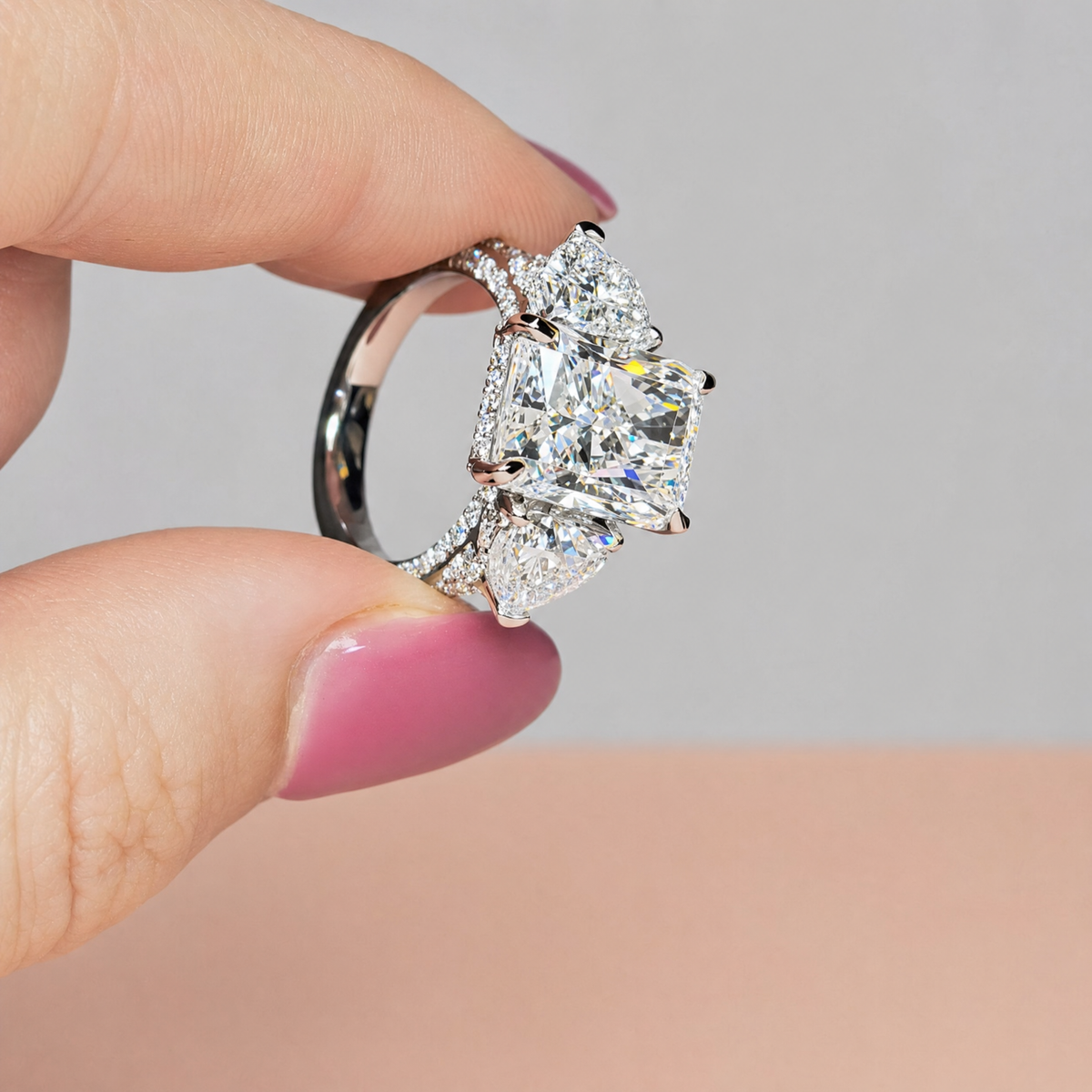 Victoria Radiant Cut Diamond Engagement Ring with Heart Cut Side Diamonds and 3D Diamond Band