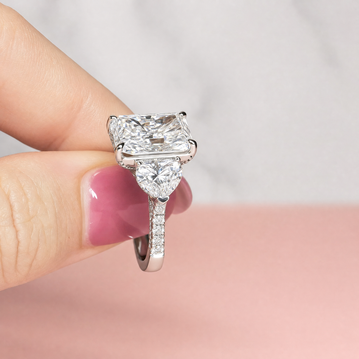 Victoria Radiant Cut Diamond Engagement Ring with Heart Cut Side Diamonds and 3D Diamond Band