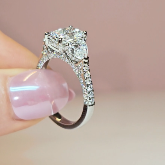 Victoria Radiant Cut Diamond Engagement Ring with Heart Cut Side Diamonds and 3D Diamond Band