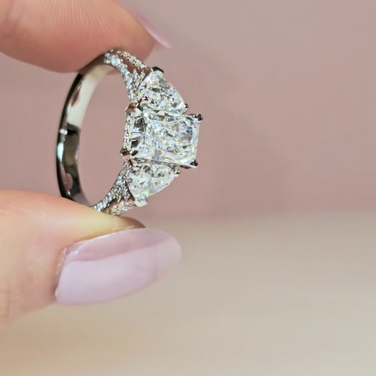 Victoria Radiant Cut Diamond Engagement Ring with Heart Cut Side Diamonds and 3D Diamond Band