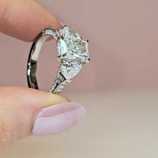 Victoria Radiant Cut Diamond Engagement Ring with Heart Cut Side Diamonds and 3D Diamond Band